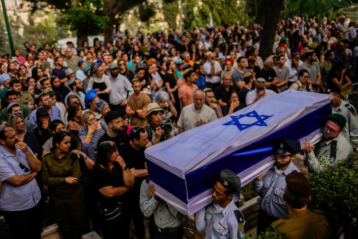 FILE - Israeli soldiers carry the flag-covered coffin of Shilo Rauchberger at the Mount Herzl c ...