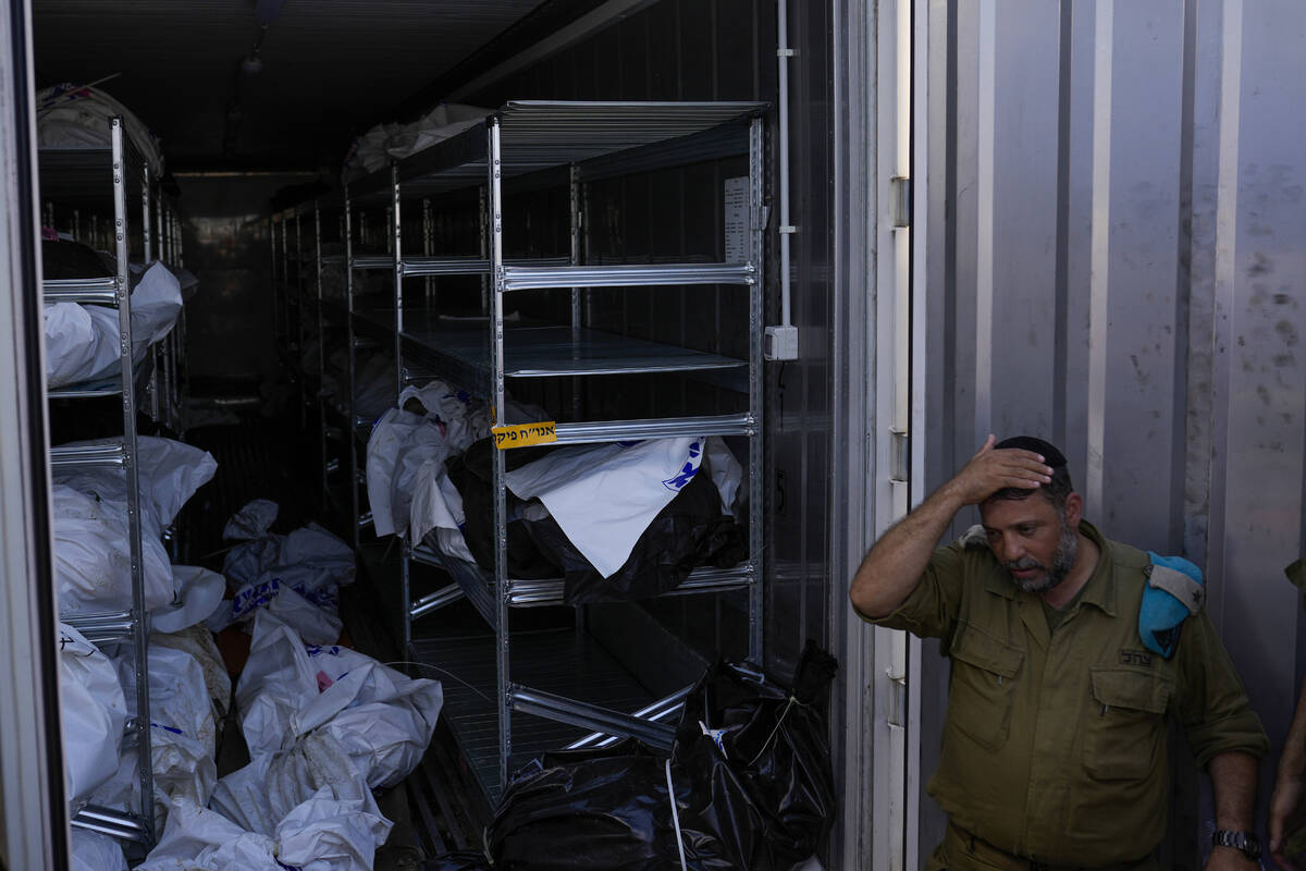 The bodies of Israelis killed in an unprecedented Hamas attack are gathered for identification ...