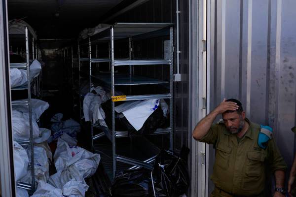 The bodies of Israelis killed in an unprecedented Hamas attack are gathered for identification ...