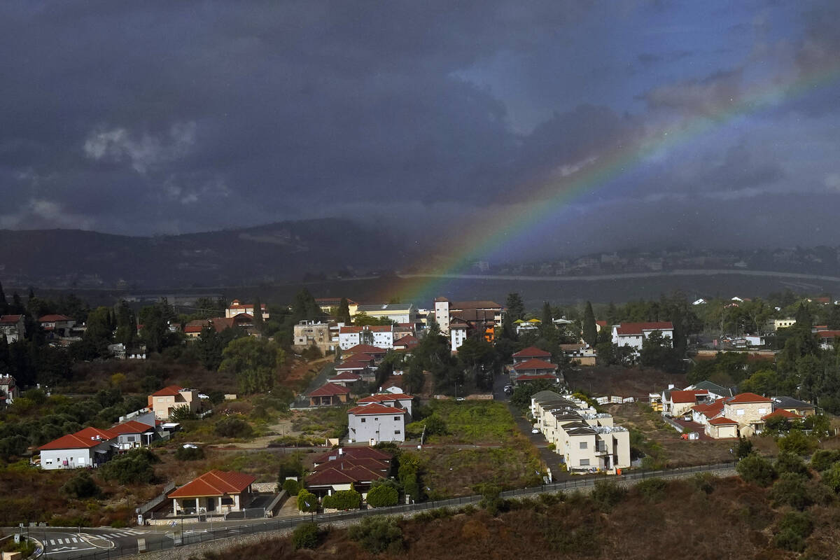 Rainbow appears over the Israeli town of Metula, as seen from the Lebanese side of the Lebanese ...