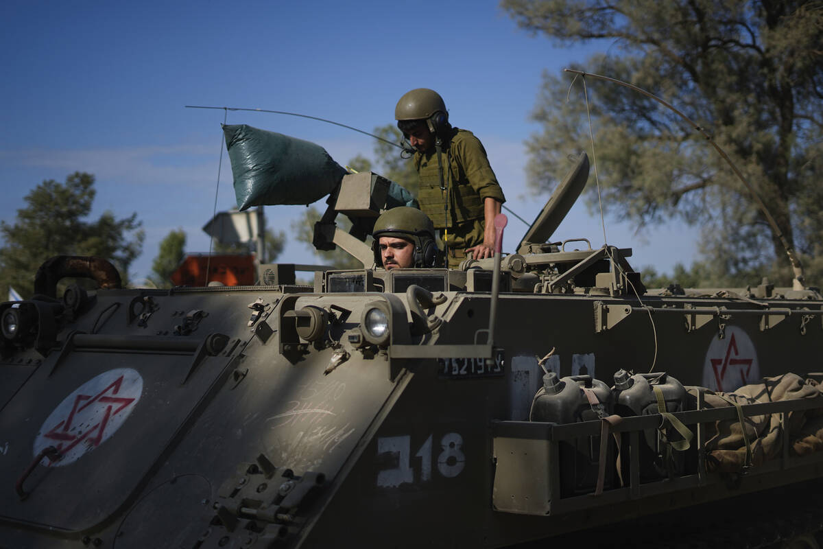 Israeli soldiers gather in a staging area near the border with Gaza Strip, in southern Israel T ...