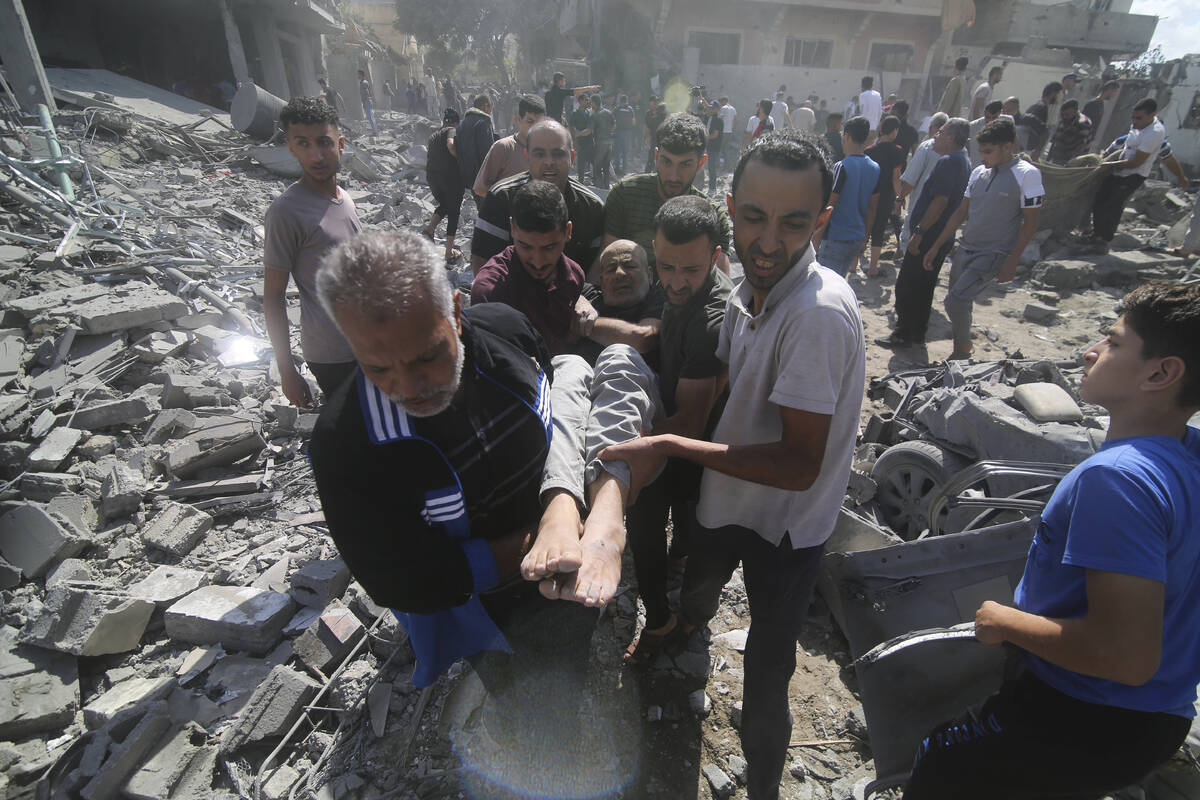 Palestinians evacuate wounded in the Israeli bombardment of Rafah, southern Gaza Strip, Tuesday ...