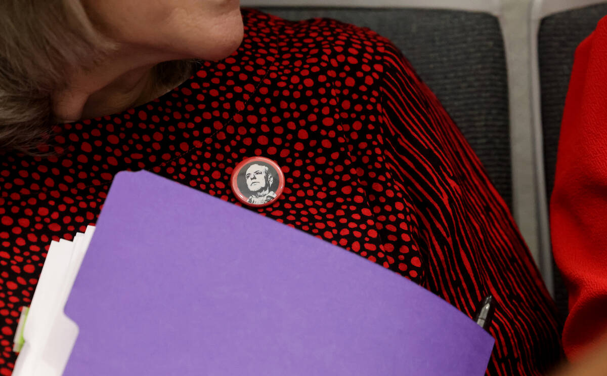 Clark County Public Administrator Rita Reid dons a button with a photo of slain reporter Jeff G ...