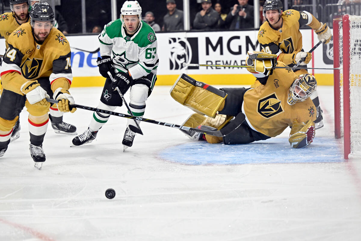 Vegas Golden Knights defenseman Nicolas Hague (14) and goaltender Adin Hill (33) defend against ...