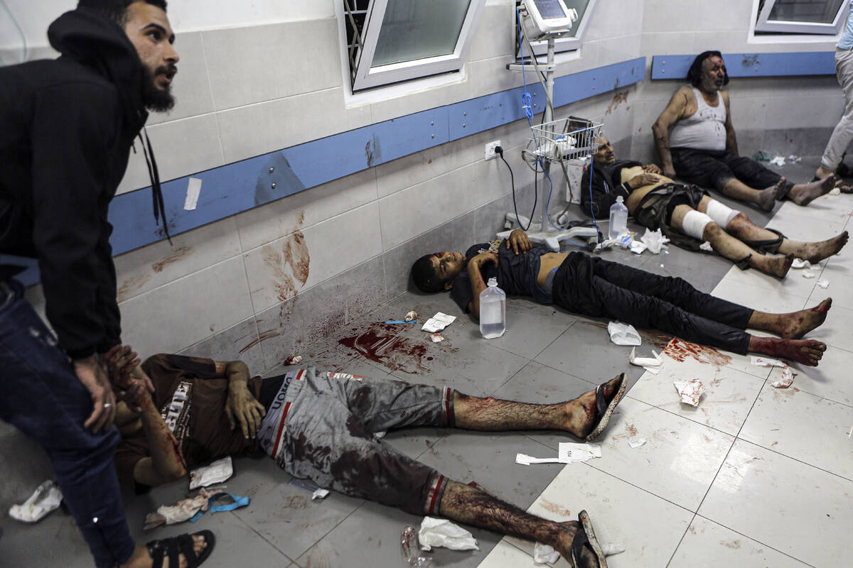 Wounded Palestinians lie on the floor in al-Shifa hospital in Gaza City, central Gaza Strip, af ...