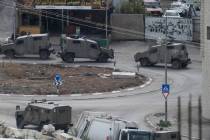 Israeli military vehicles are seen during a raid on Nur Shams refugee camp in the West Bank on ...