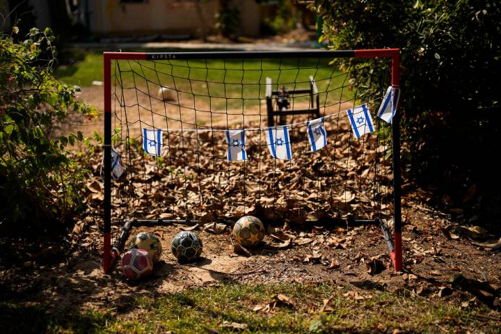 Israel flags hang in a soccer goal in a backyard of a home that came under attack during a mass ...