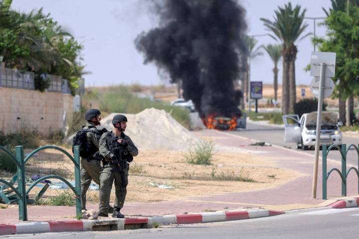 Israeli soldiers take position at the southern Israeli town of Ofakim on Sunday, Oct.8, 2023. H ...