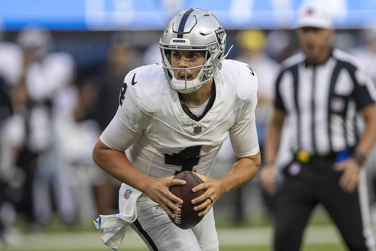 Raiders quarterback Aidan O'Connell (4) looks to throw during the second half an NFL game again ...