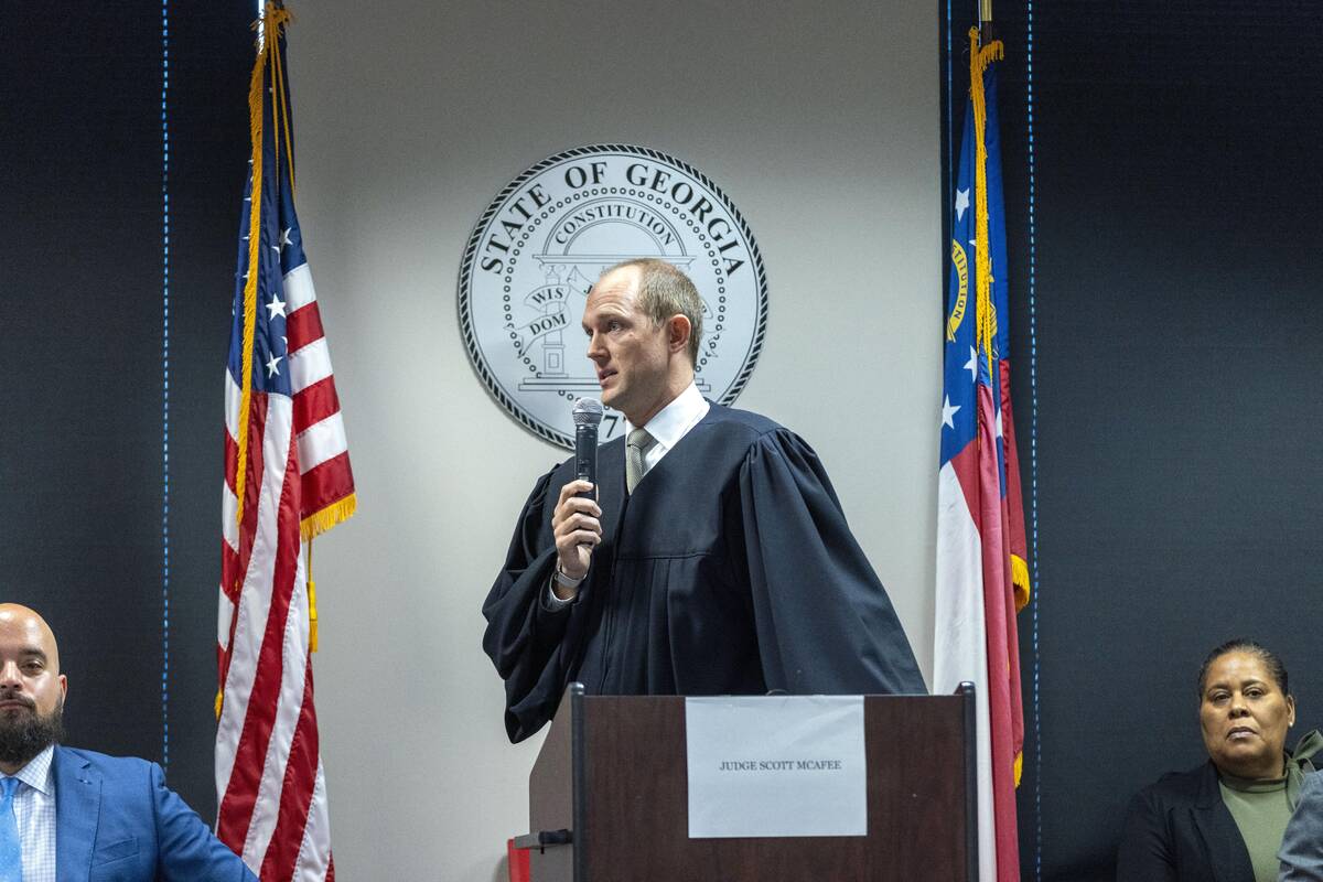 Fulton Superior Court Judge Scott McAfee addresses potential jurors during jury selection for l ...