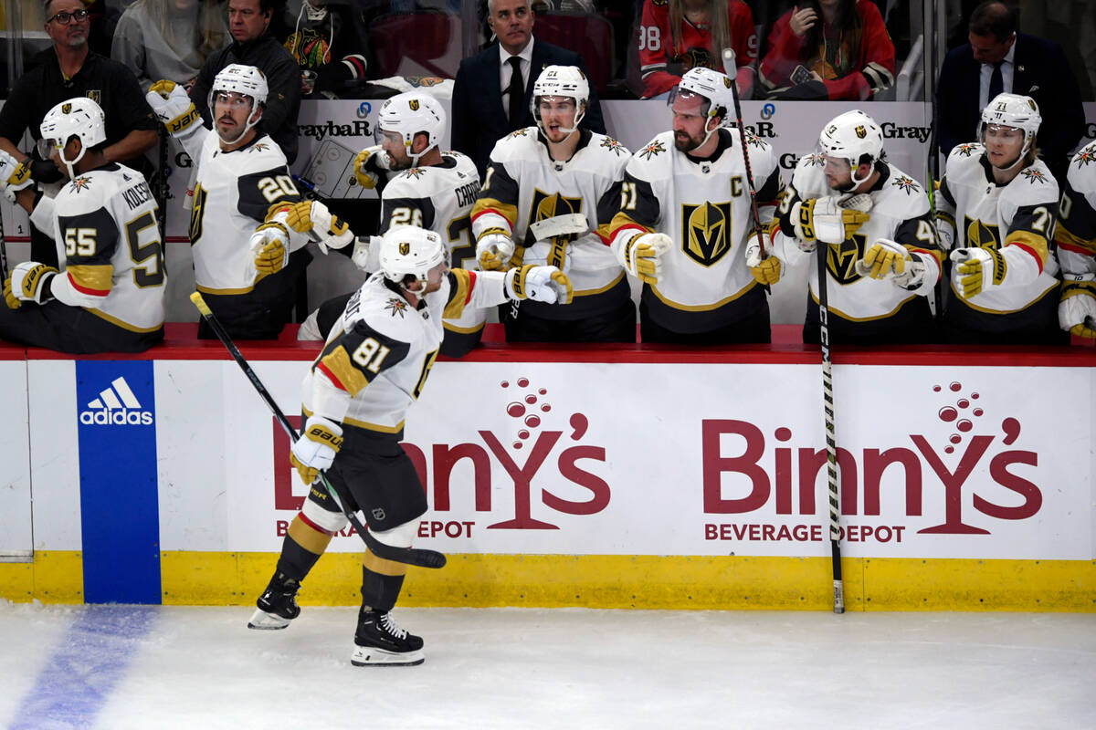 Vegas Golden Knights' Jonathan Marchessault (81) celebrates with teammates at the bench after s ...