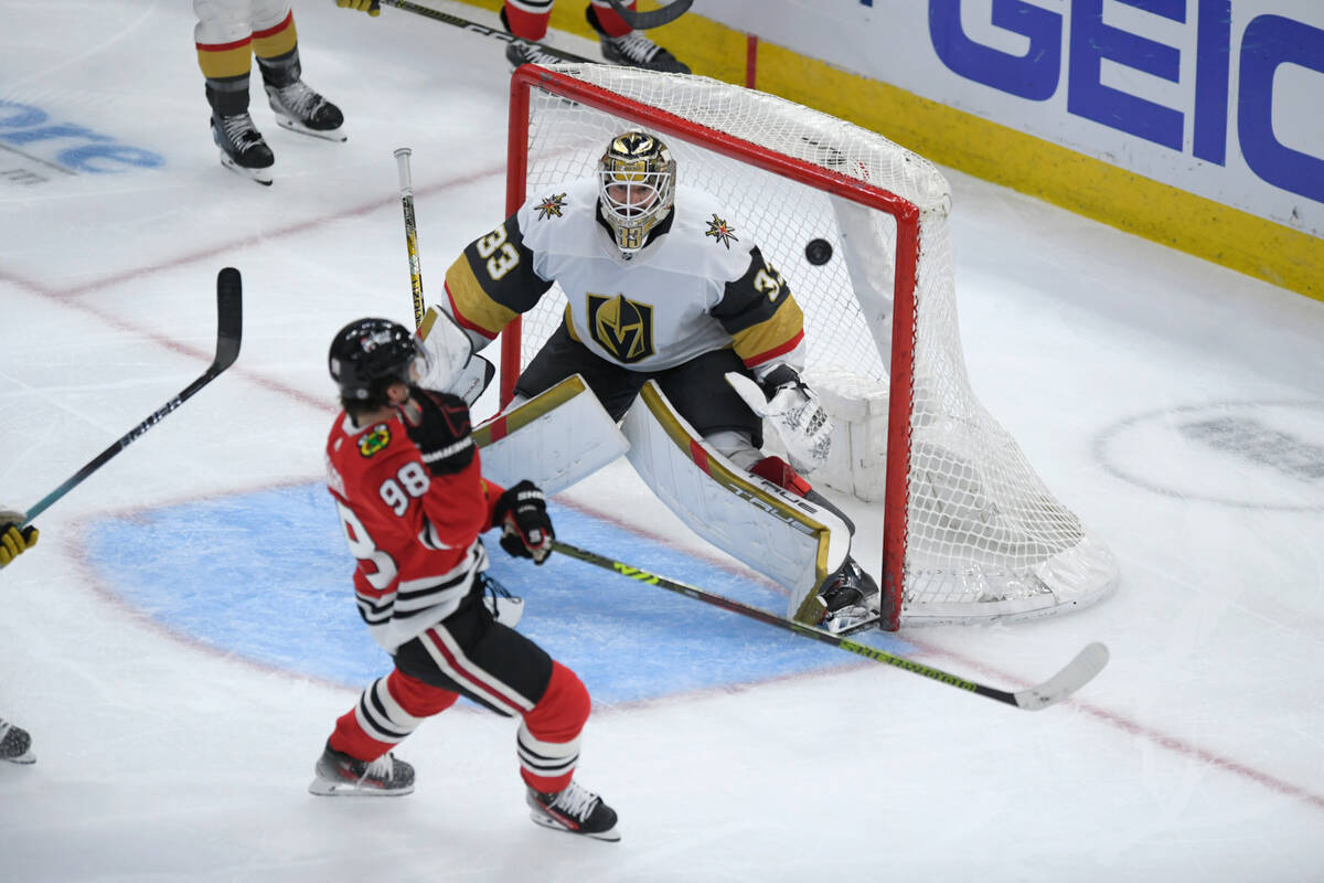 Chicago Blackhawks' Connor Bedard (98) shoots on goal against Vegas Golden Knights goalie Aidin ...