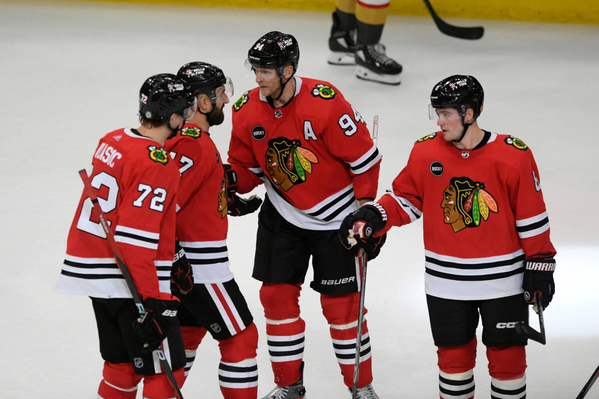 Chicago Blackhawks' Corey Perry (94) celebrates with teammates Alex Vlasic (72), Ryan Donato (8 ...