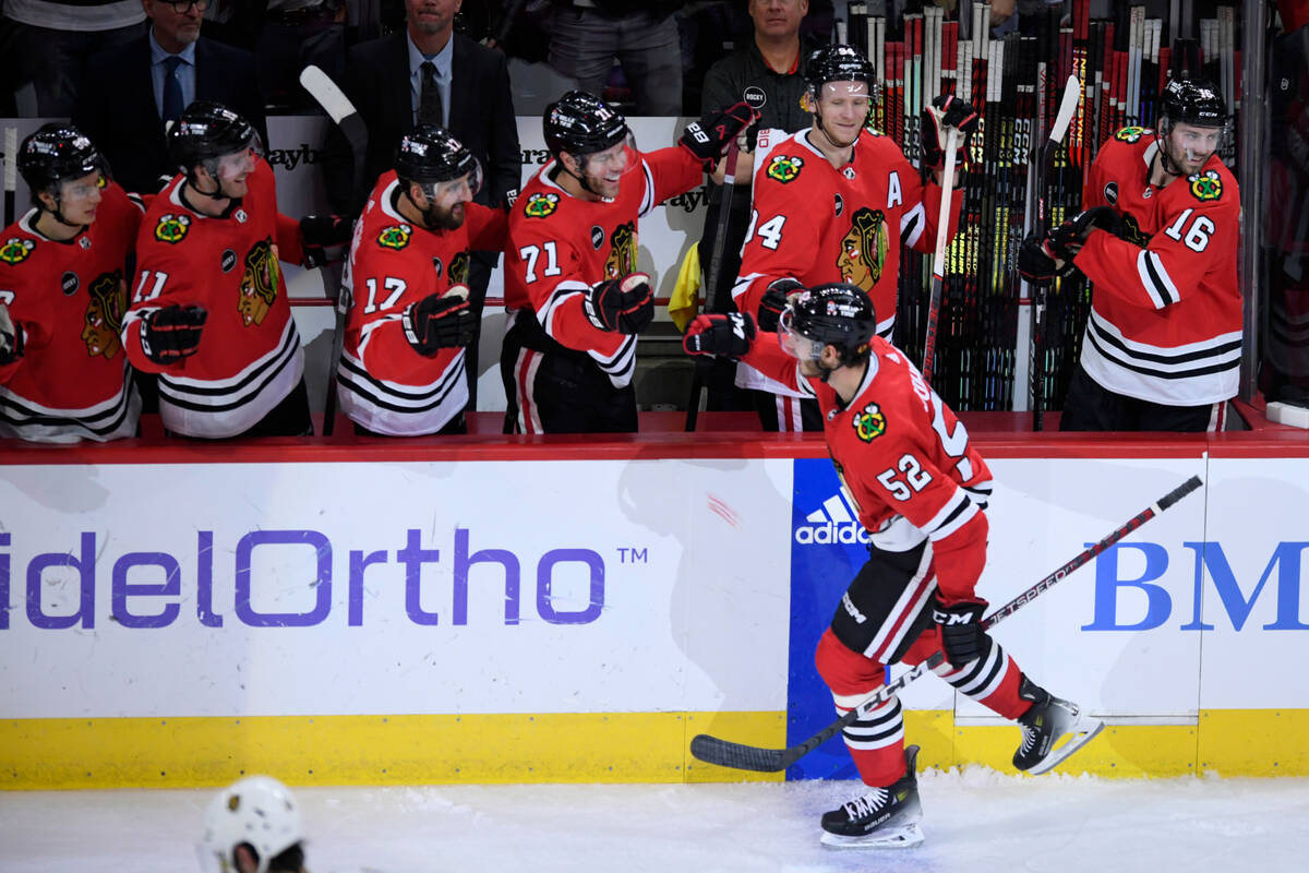 Chicago Blackhawks' Reese Johnson (52) celebrates with teammates at the bench after scoring dur ...