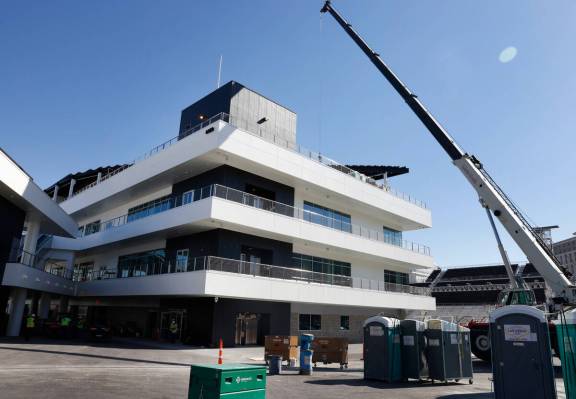 Workers are seen as they add the finishing touches to The F1 Pit Building during a media tour, ...