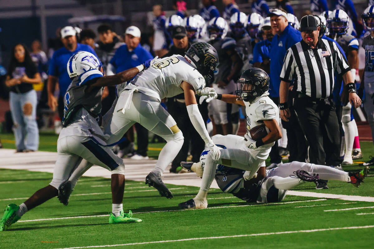 Foothill wide receiver Chase Kennedy (5) falls onto a Basic player during a game at Basic Acade ...