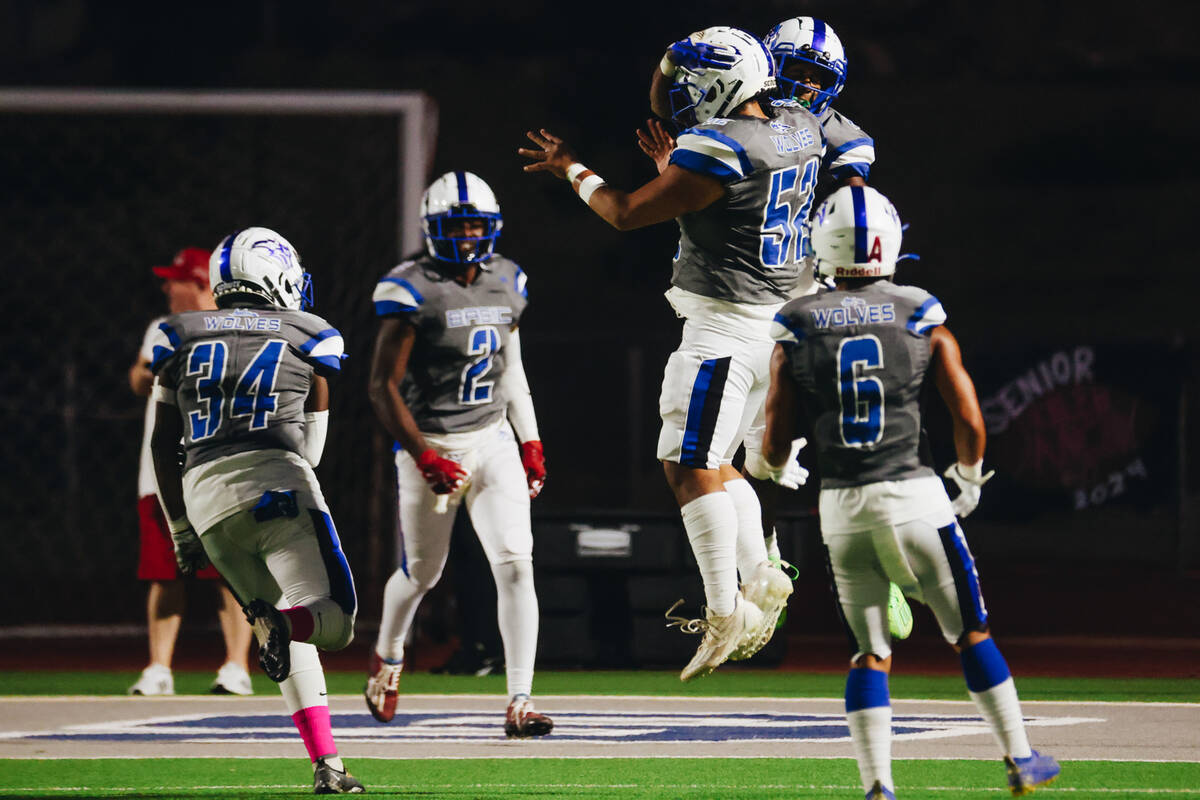 Basic players celebrate a touchdown during a game against Foothill at Basic Academy on Friday, ...