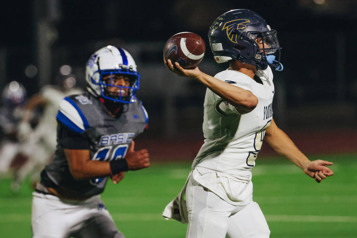 Foothill quarterback Mason Dew (9) throws the ball to a teammate during a game at Basic Academy ...