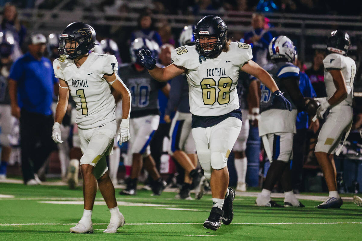 Foothill players celebrate an interception during a game against Basic at Basic Academy on Frid ...