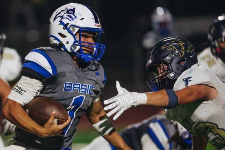 Basic quarterback Anthony Vega (1) runs the ball past a Foothill defender during a game at Basi ...