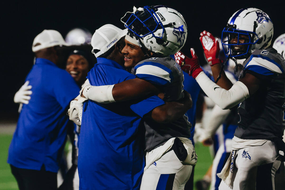 Basic players and coaching staff celebrate their win over Foothill following a game at Basic Ac ...