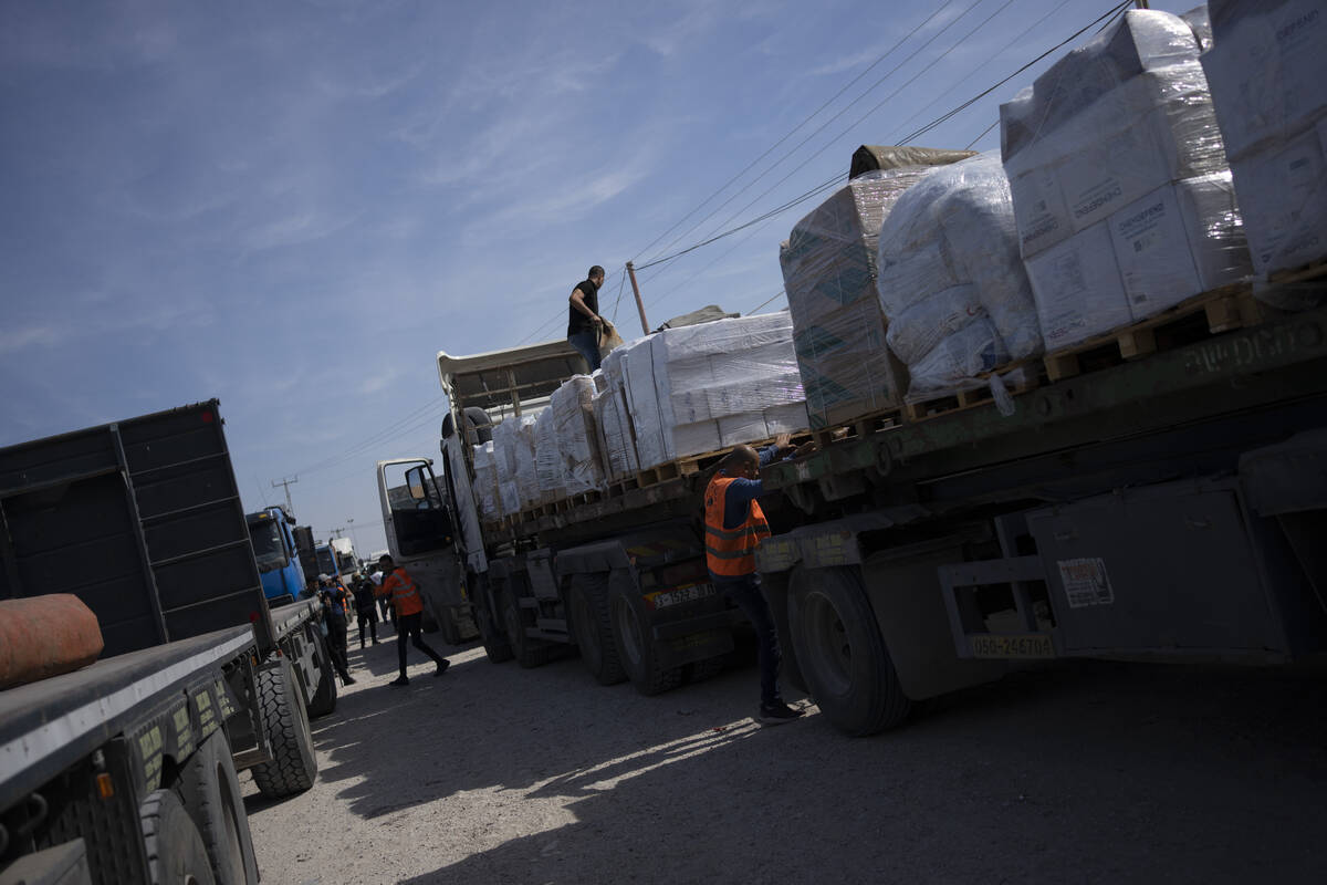 Trucks with humanitarian aid for the 'Gaza Strip enter from Egypt in Rafah on Saturday, Oct. 21 ...