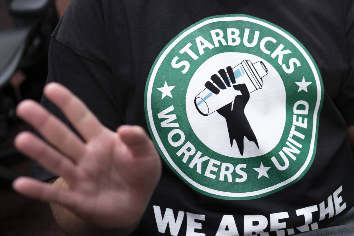 File - The Starbucks Workers United logo appears on the shirt of a former Starbucks employee at ...