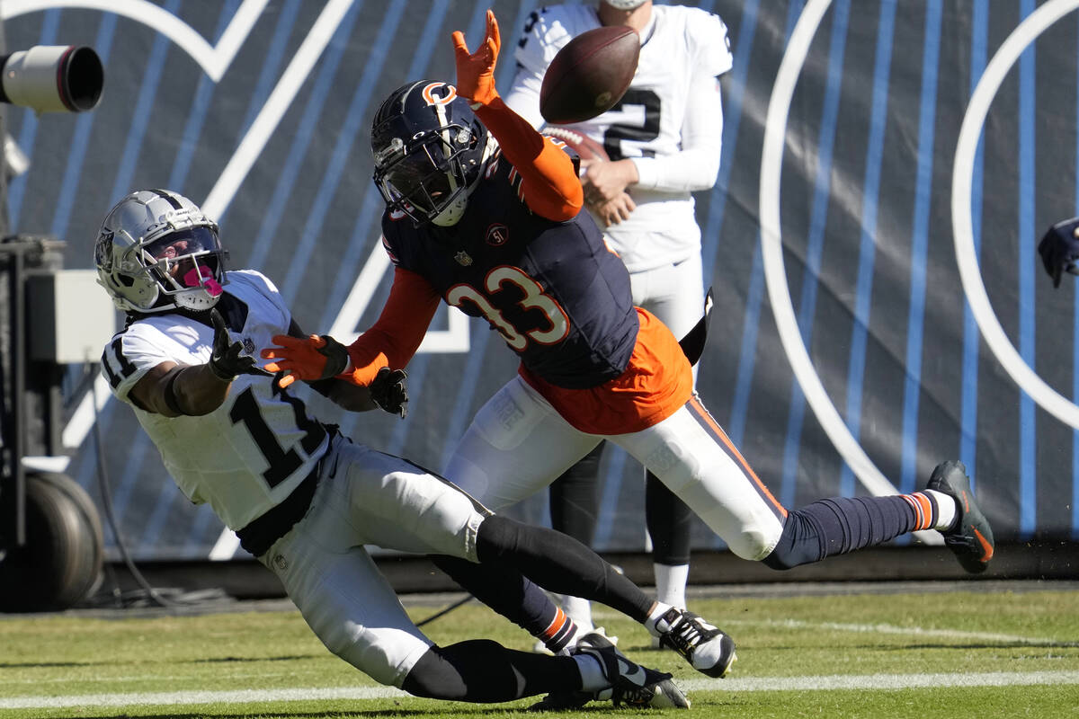 Las Vegas Raiders wide receiver Tre Tucker (11) cannot hold onto a pass as he is defended by Ch ...