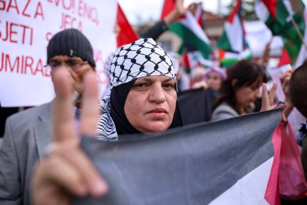 A woman shows a peace sign during a protest against Israel and in support of Palestinians in Sa ...
