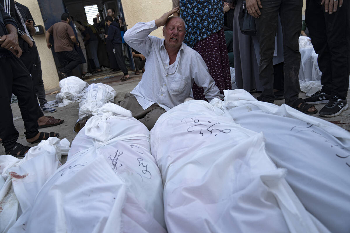 Palestinians mourn their relatives killed in the Israeli bombardment of the Gaza Strip at Al-Aq ...