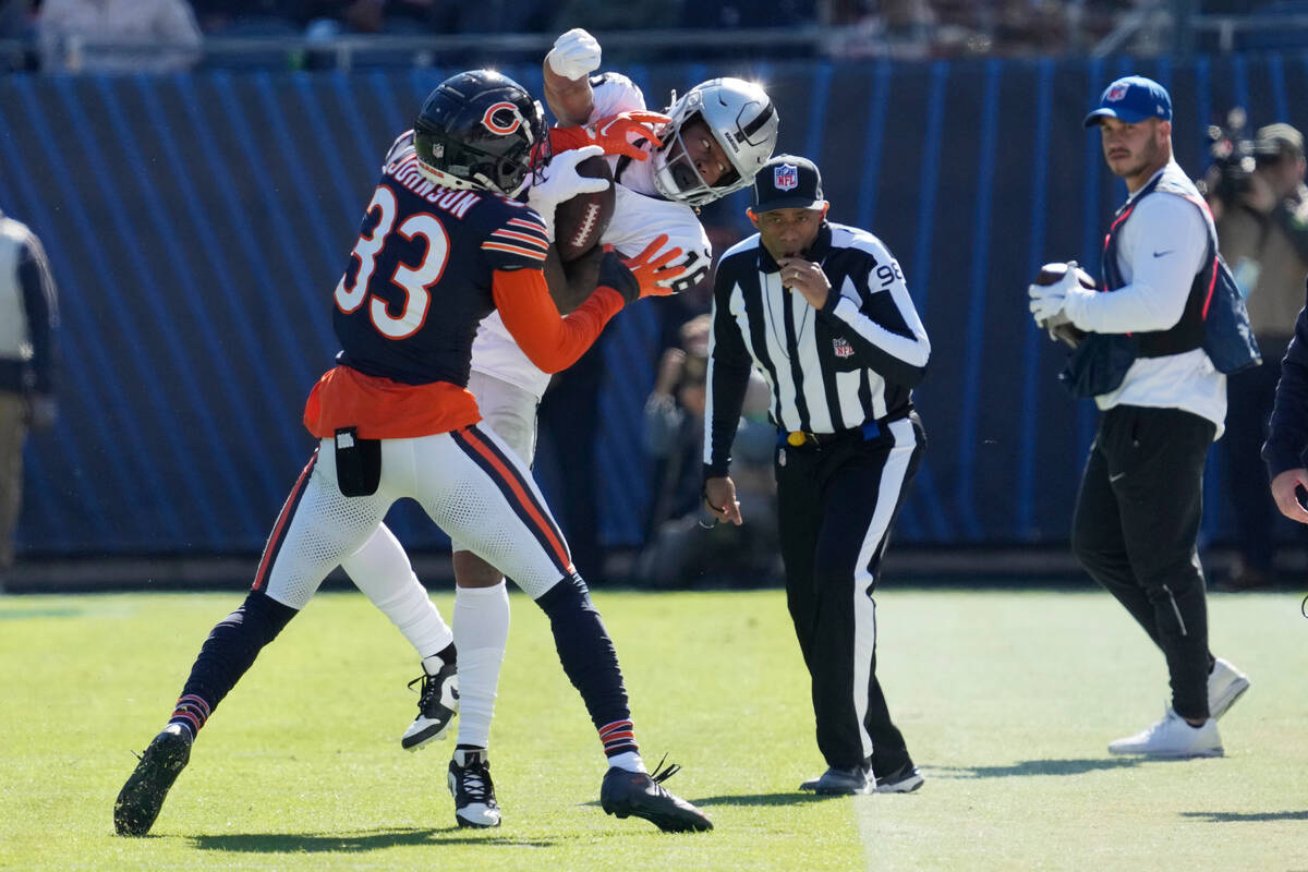 Las Vegas Raiders wide receiver Jakobi Meyers (16) is pushed out of bounds by Chicago Bears cor ...