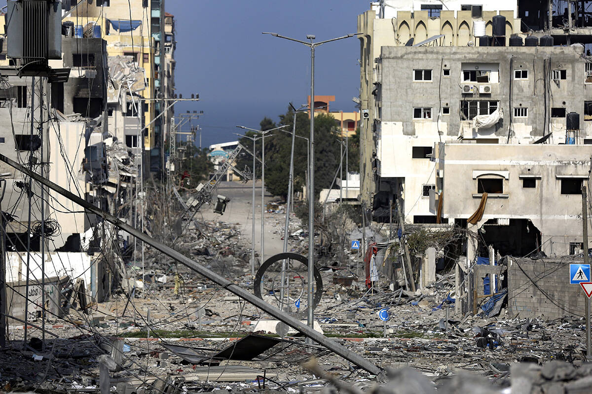 A damaged neighborhood following Israeli airstrikes on Gaza City, Monday, Oct. 23, 2023. (AP Ph ...