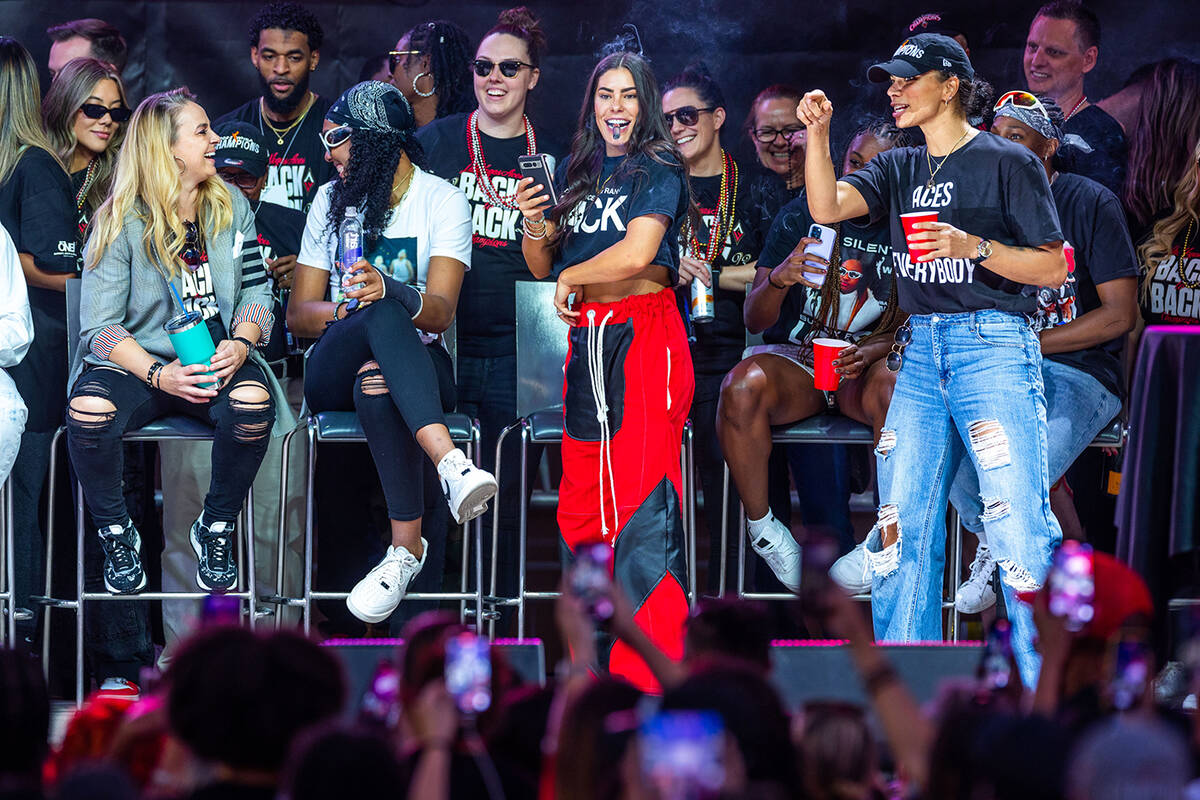 Aces players laugh with coach Becky Hammon during their championship celebration at Toshiba Pla ...