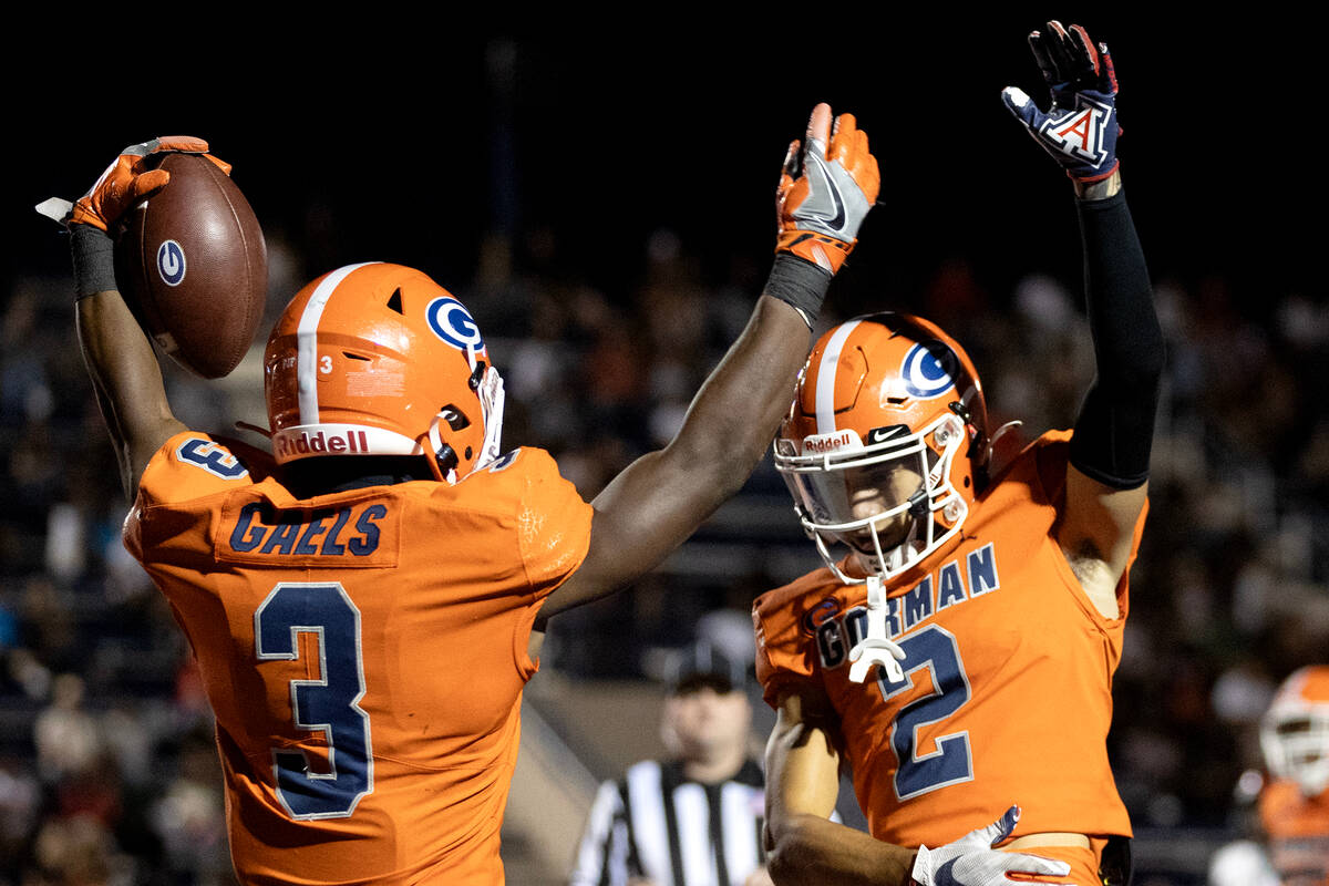 Bishop Gorman’s Devon Rice (3) and Audric Harris (2) celebrate Rice’s touchdown d ...