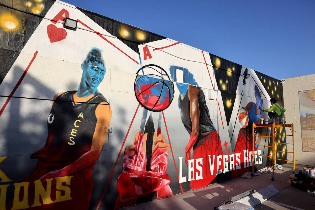 Artist Juan Ochoa paints a mural honoring the WNBA champion Aces on Main Street north of Imperi ...