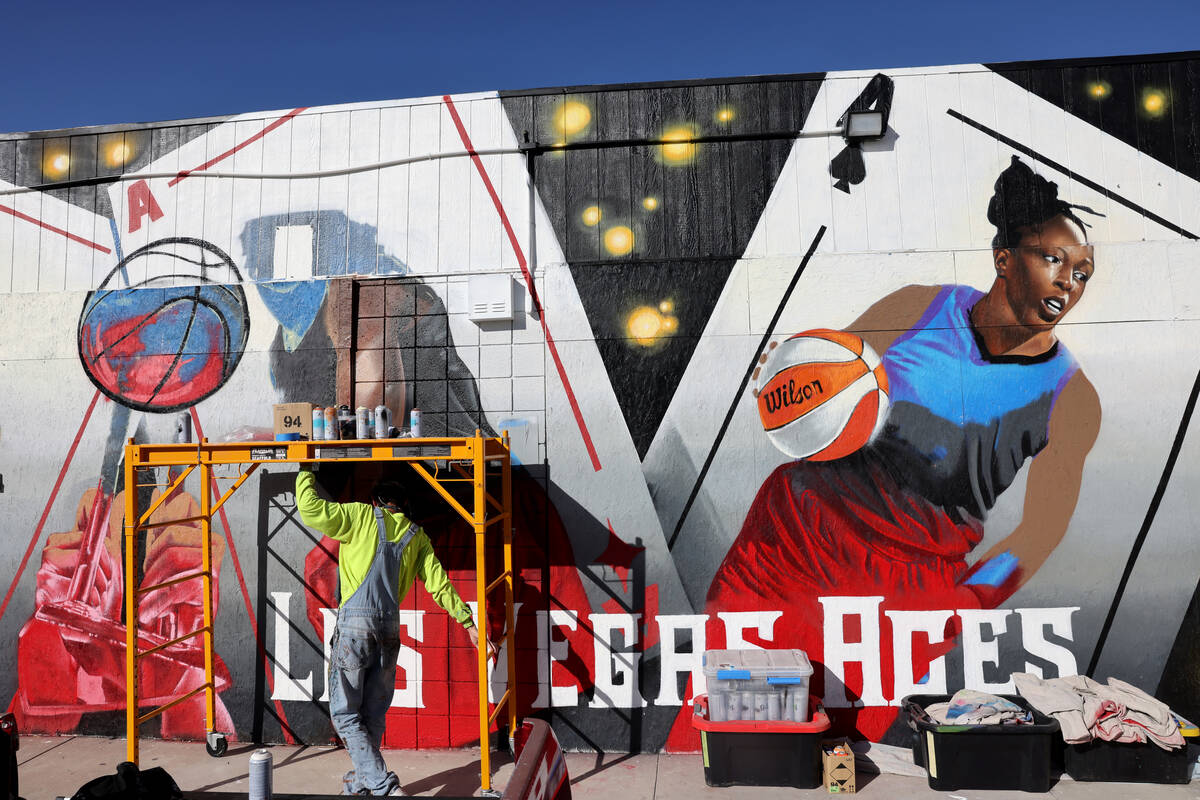 Artist Juan Ochoa paints a mural honoring the WNBA champion Aces on Main Street north of Imperi ...