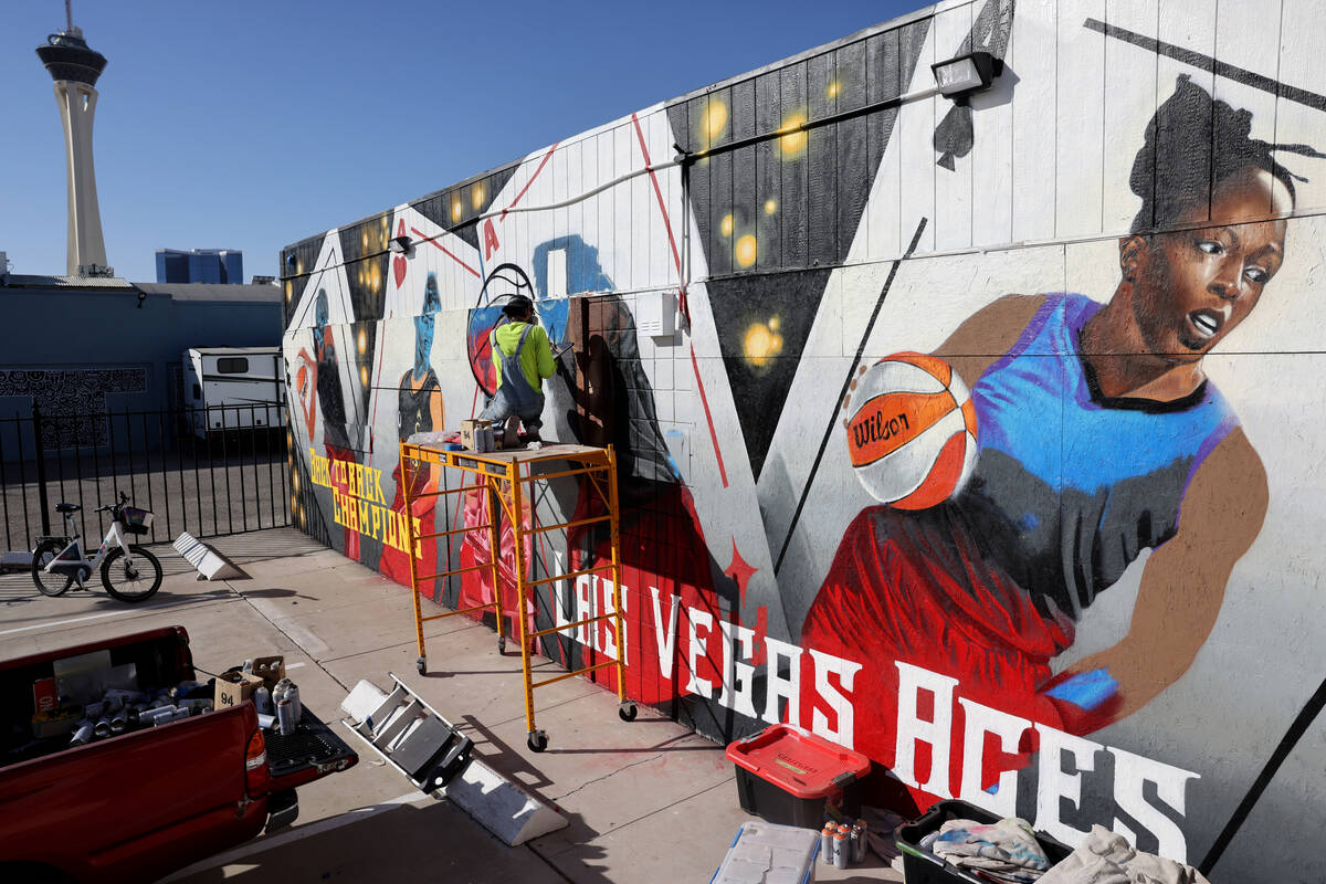 Artist Juan Ochoa paints a mural honoring the WNBA champion Aces on Main Street north of Imperi ...