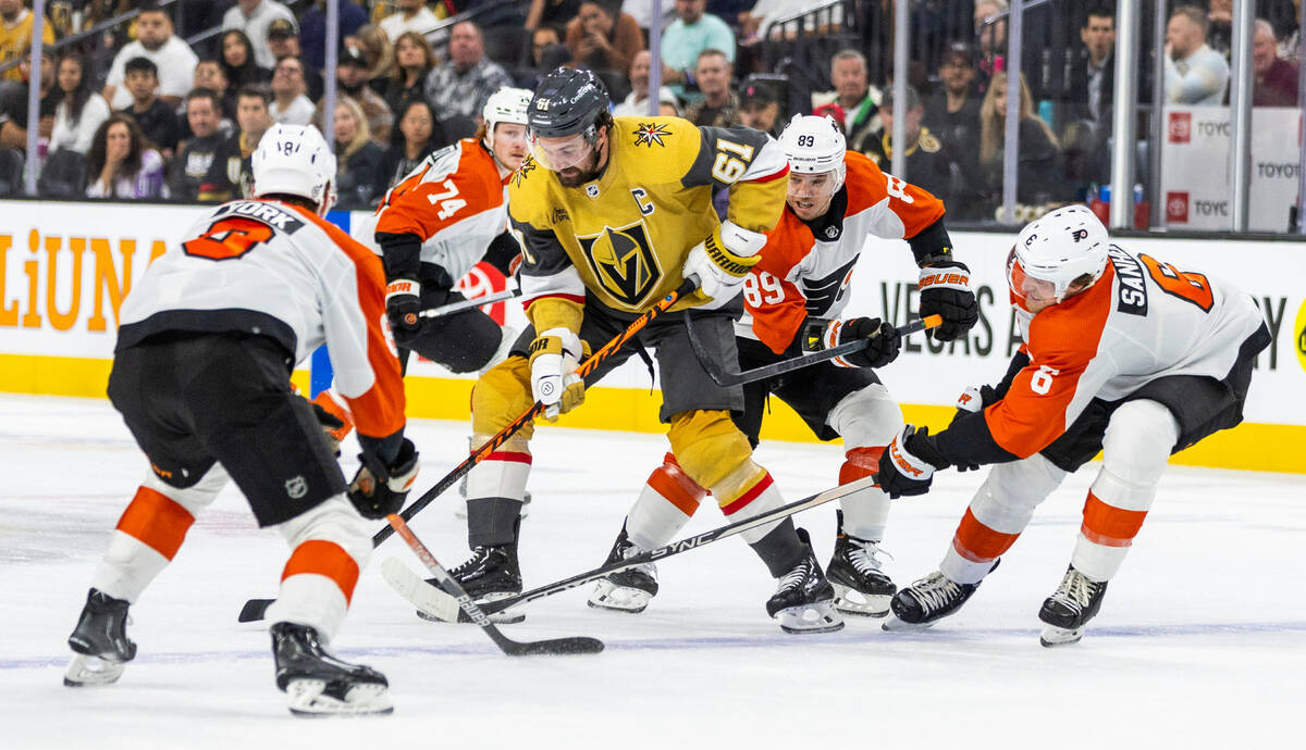 Golden Knights right wing Mark Stone (61) fights for the puck amongst Philadelphia Flyers defen ...