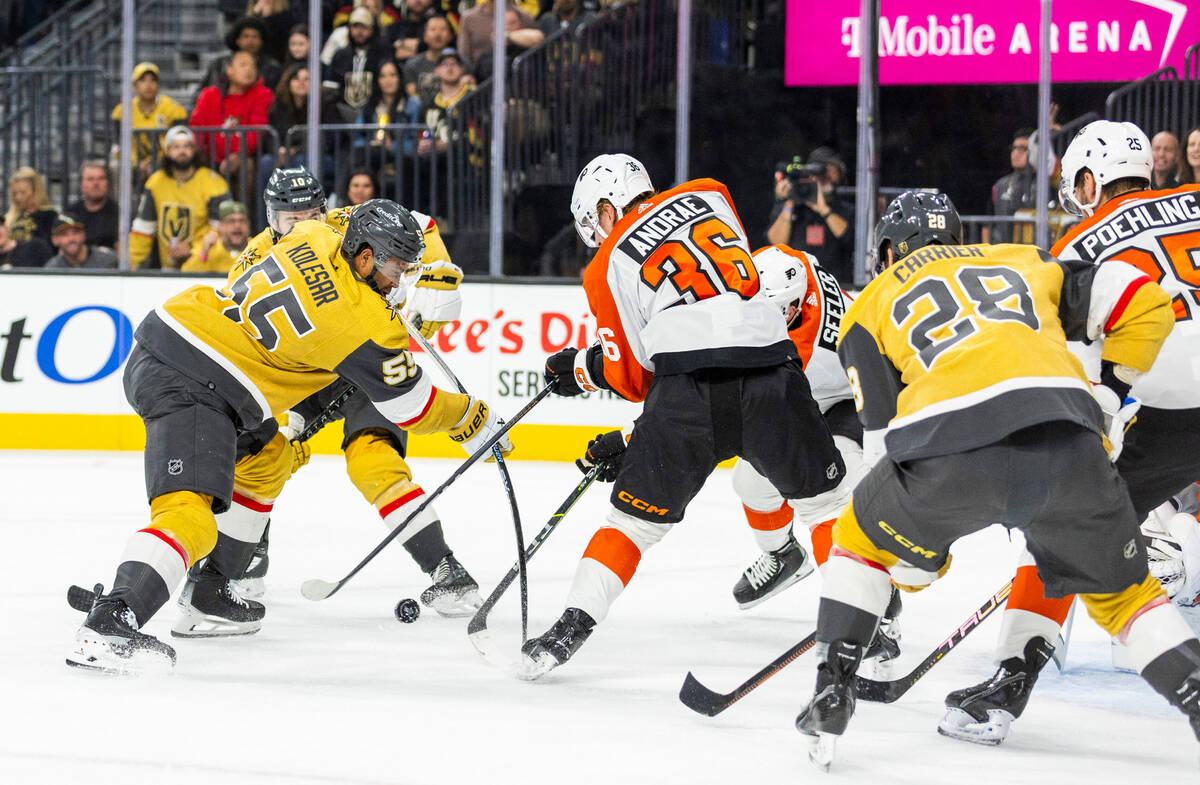 Golden Knights right wing Keegan Kolesar (55) battles for the puck with Philadelphia Flyers def ...