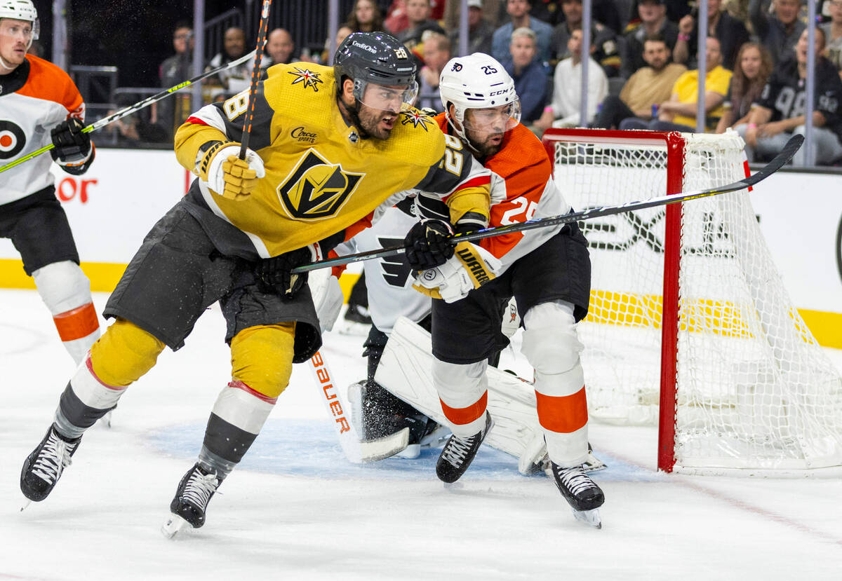 Golden Knights left wing William Carrier (28) battles for position with Philadelphia Flyers cen ...