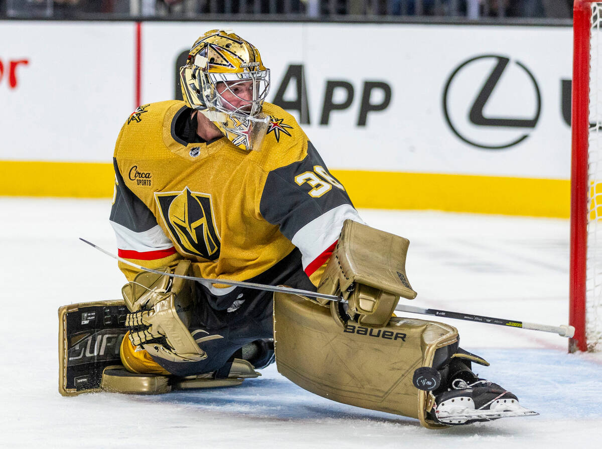 Golden Knights goaltender Logan Thompson (36) deflects a shot away off his skatet by the Philad ...