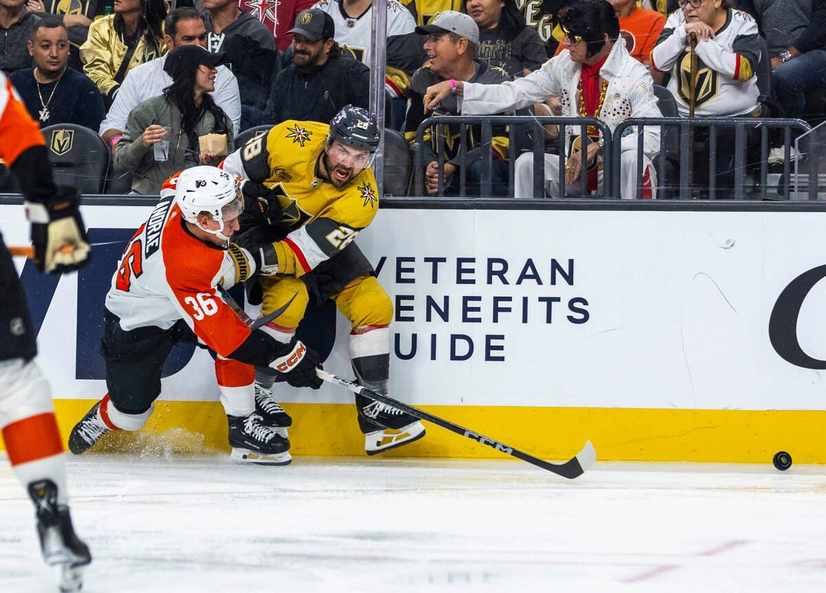 Golden Knights left wing William Carrier (28) tangles with Philadelphia Flyers defenseman Emil ...