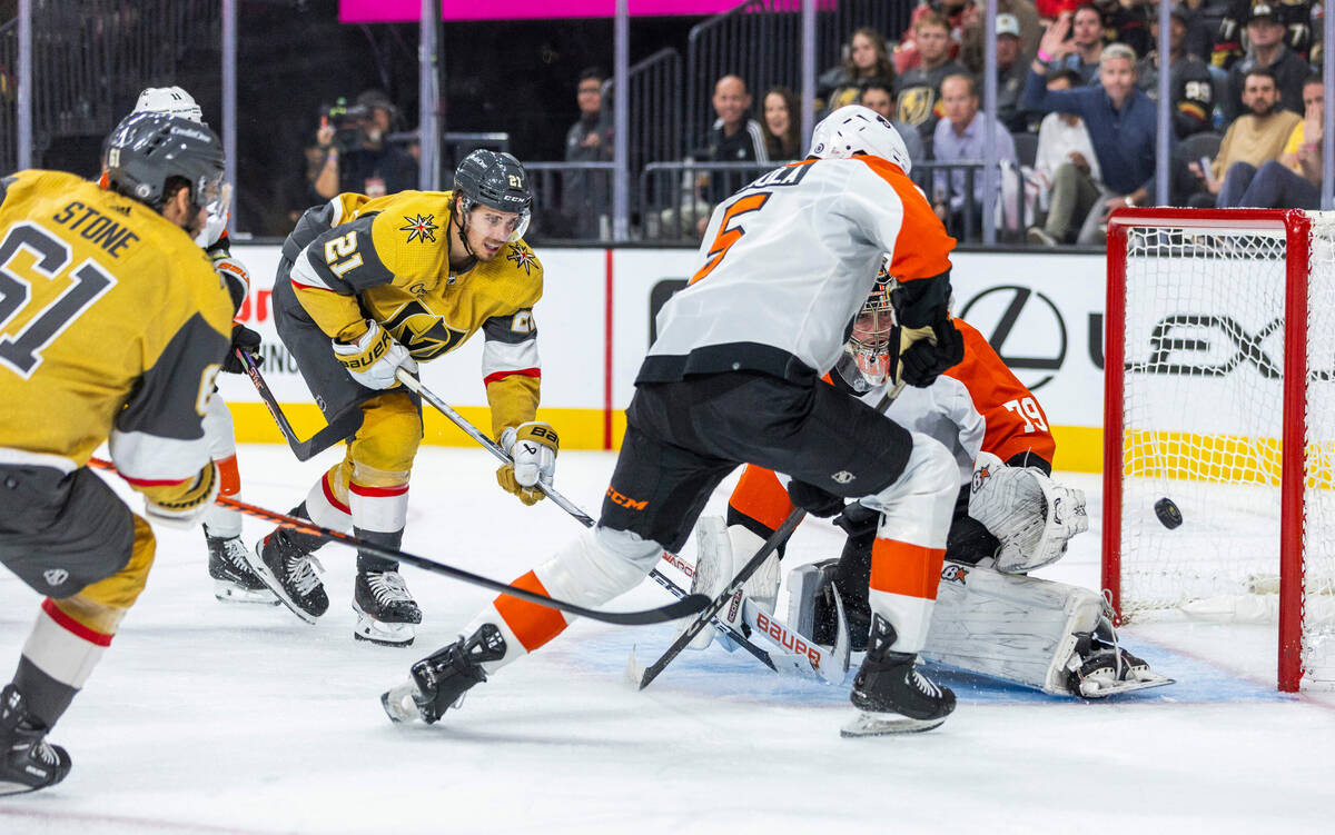 Golden Knights center Brett Howden (21) shoots on Philadelphia Flyers goaltender Carter Hart (7 ...