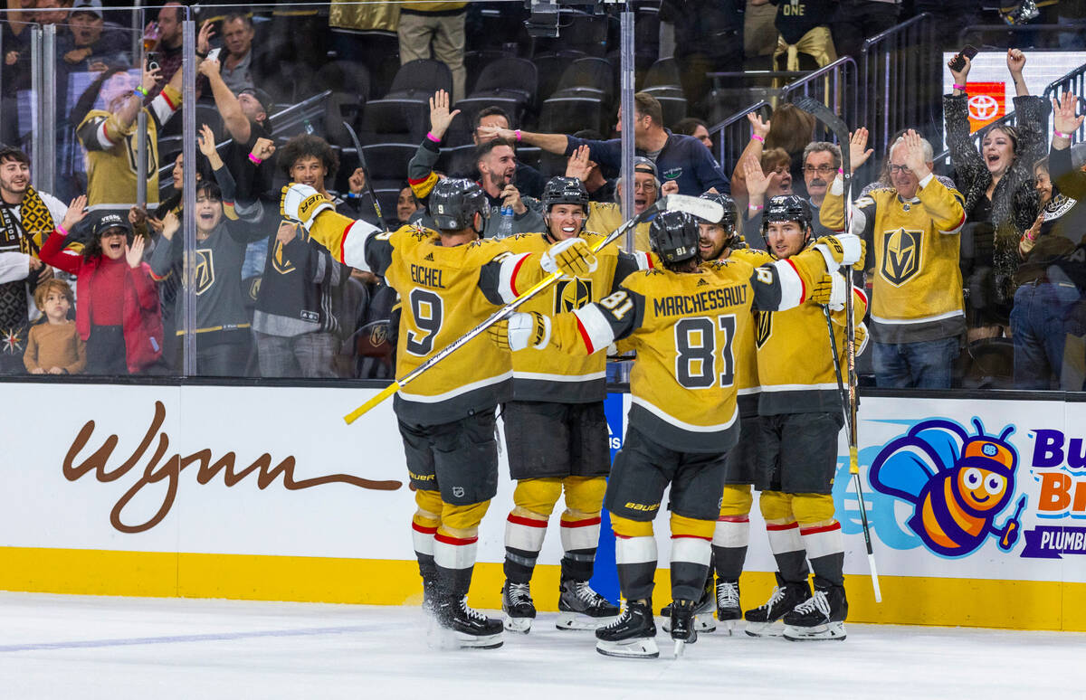 Golden Knights players celebrate the winning goal by defenseman Shea Theodore (27) over Philade ...