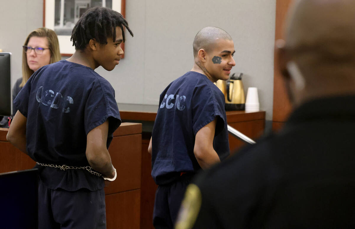 Jesus Ayala, 18, right, and Jzamir Keys, 16, smile at the wife and daughter of the victim as th ...