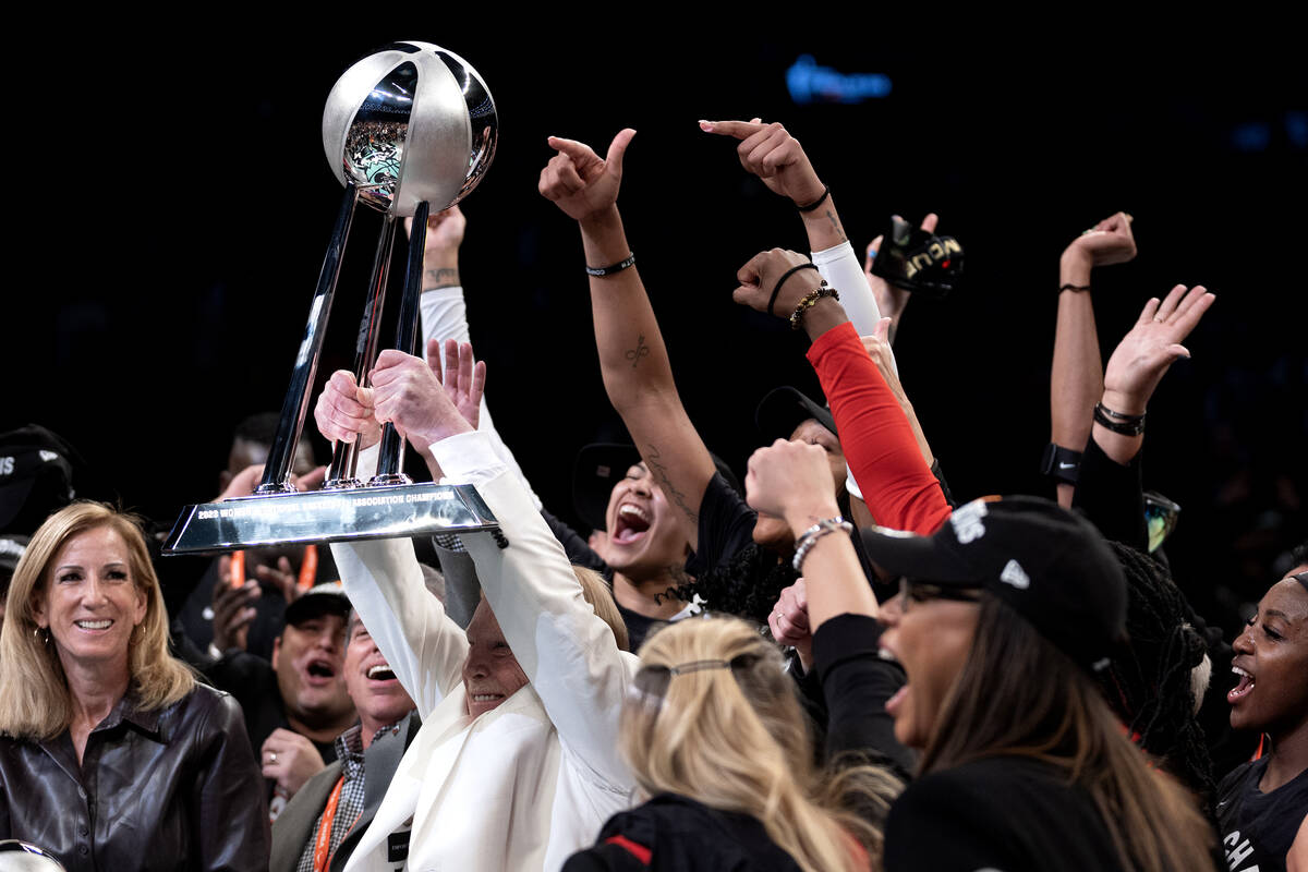 Las Vegas Aces owner Mark Davis hold up his team’s championship trophy after they won Ga ...