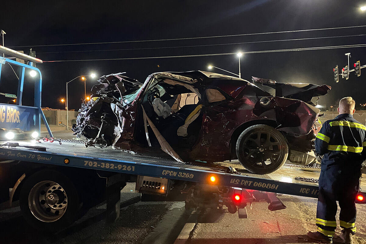 What's left of Gary Dean Robinson's Dodge Challenger is loaded on a truck bed after the crash a ...