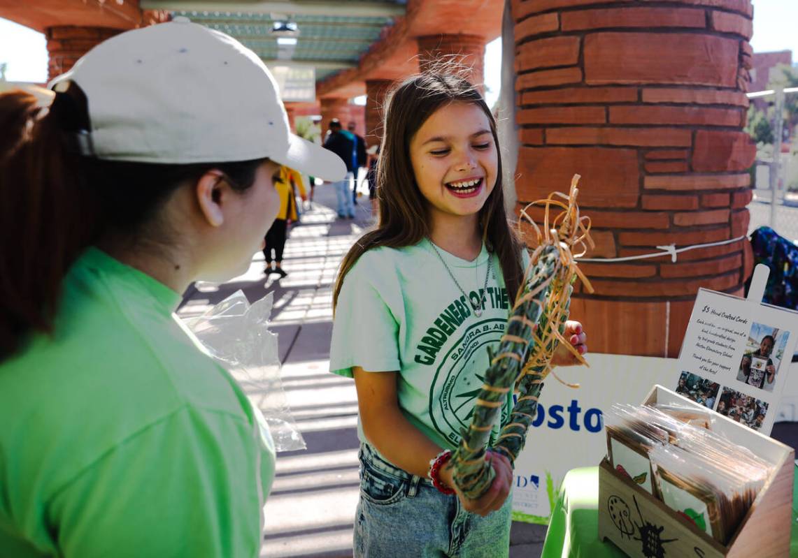 Victoria Zemskov, 10, shows Abston Elementary’s goods for sale to customer Andrea Martinez at ...