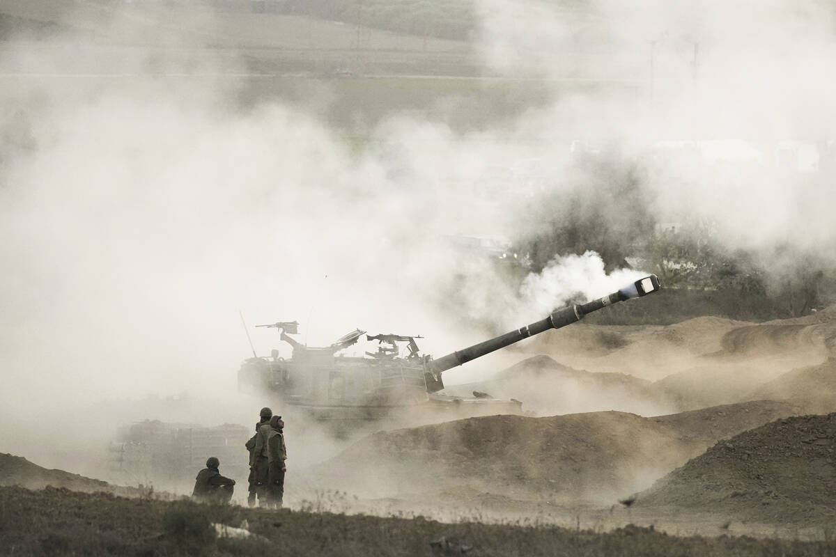 An Israeli mobile artillery unit fires a shell from southern Israel towards the Gaza Strip, in ...