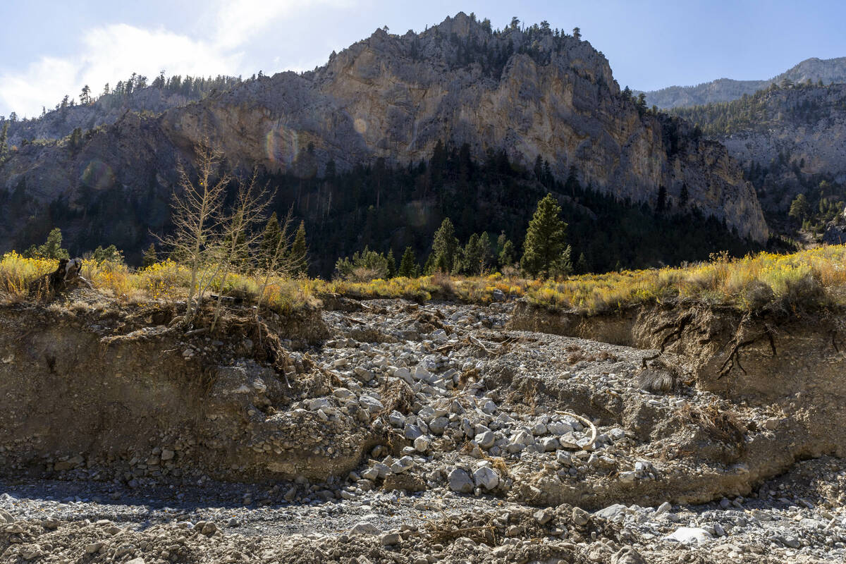 The path of rushing water carves out a deeper wash into another along Echo Road as repairs cont ...